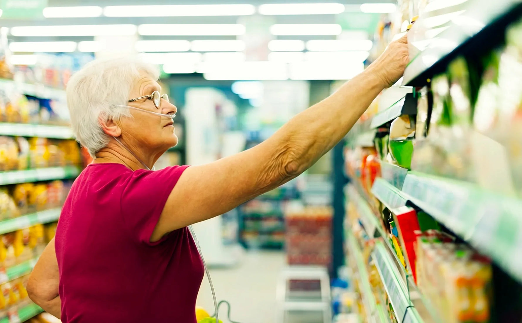 Old lady using a nasal cannula at the supermarket.